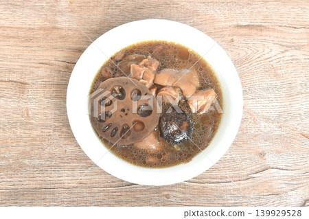 boiled pork knuckle with peanut and lotus root couple ginger topping black mushroom soup on bowl 139929528