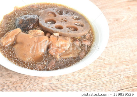 boiled pork knuckle with peanut and lotus root couple ginger topping black mushroom soup on bowl 139929529