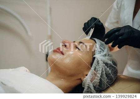 Professional skincare. Close-up of a facial treatment with a cosmetic device in a beauty clinic 139929824