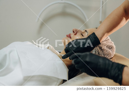 Professional skincare. Close-up of a facial treatment with a cosmetic device in a beauty clinic Professional skincare. Close-up of a facial treatment with a cosmetic device in a beauty clinic 139929825