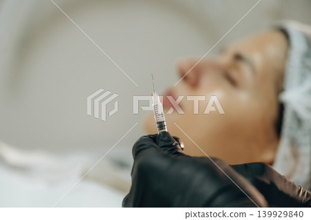 Cosmetologist performing a facial injection procedure in a beauty clinic Cosmetologist performing a facial injection procedure in a beauty clinic 139929840