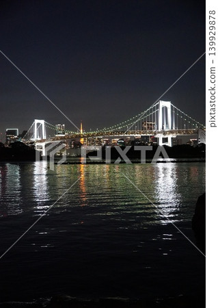 A night view of the Rainbow Bridge and Tokyo Tower from Odaiba Seaside Park. A night view of the Rainbow Bridge and Tokyo Tower from Odaiba Seaside Park. 139929878