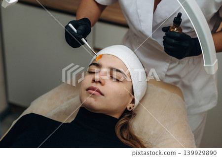 Getting ready. Close-up of a facial skincare treatment with a cosmetic device in a beauty clinic Getting ready. Close-up of a facial skincare treatment with a cosmetic device in a beauty clinic 139929890