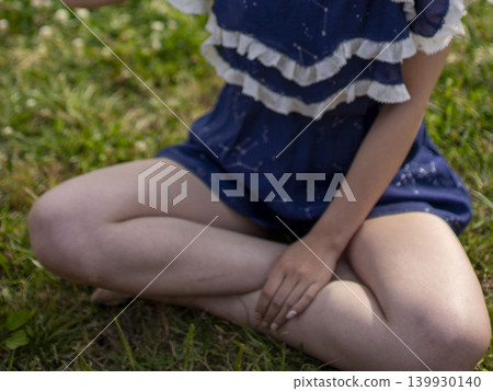 A girl sitting on the lawn A girl sitting on the lawn 139930140