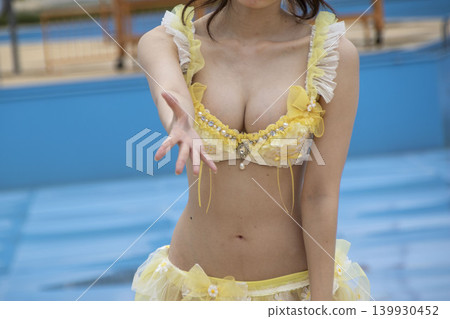A woman in a swimsuit reaches out her hand. A woman in a swimsuit reaches out her hand. 139930452