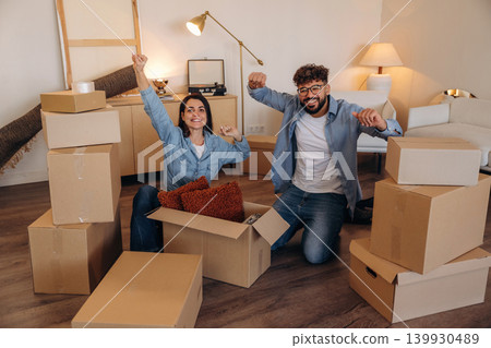 Playful couple enjoying time together while moving into a new home Playful couple enjoying time together while moving into a new home 139930489
