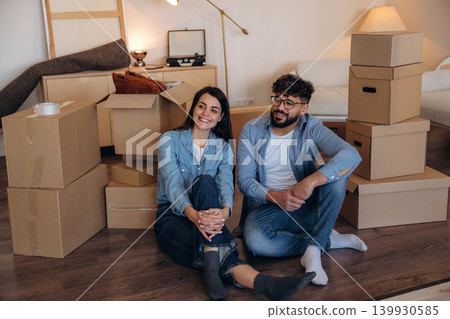 Playful couple enjoying time together while moving into a new home Playful couple enjoying time together while moving into a new home 139930585