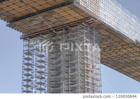 Bridge pier construction, scaffolding, elevated bridge under construction, infrastructure work, steel frame, building site, civil engineering work. Bridge pier construction, scaffolding, elevated bridge under construction, infrastructure work, steel frame, building site, civil engineering work. 139930694