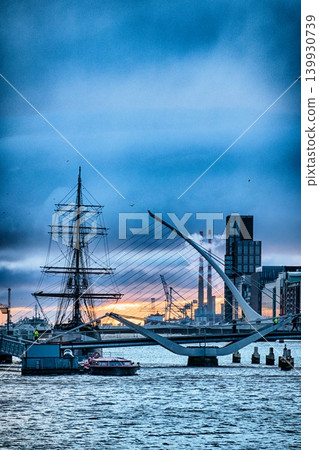 Samuel Beckett Bridge and Jeanie Johnston Famine Ship in Dublin Ireland at Sunrise with River Liffey 139930739