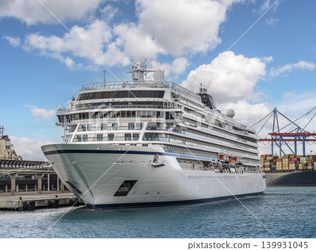 Luxury Cruise Ship Docked at Busy Port With Container Terminal and Blue Sky Luxury Cruise Ship Docked at Busy Port With Container Terminal and Blue Sky 139931045