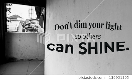 A black and white photo of a wall with a window, displaying the quote, Don't dim your light so others can SHINE. A black and white photo of a wall with a window, displaying the quote, Don't dim your light so others can SHINE. 139931305