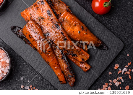Grilled or barbecued carrot slices with salt and spices. Grilled carrots Grilled or barbecued carrot slices with salt and spices. Grilled carrots 139931629