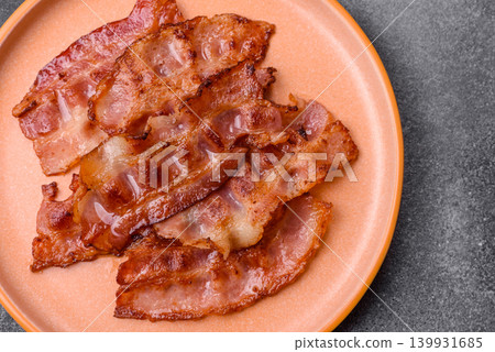 Fried fresh bacon slices with layers of meat or prosciutto with salt and spices. Fried bacon Fried fresh bacon slices with layers of meat or prosciutto with salt and spices. Fried bacon 139931685