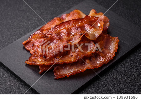 Fried fresh bacon slices with layers of meat or prosciutto with salt and spices. Fried bacon Fried fresh bacon slices with layers of meat or prosciutto with salt and spices. Fried bacon 139931686