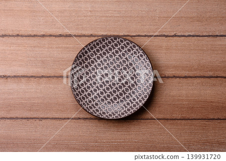 An empty ceramic round plate, kitchen utensils for a dinner table. An empty plate An empty ceramic round plate, kitchen utensils for a dinner table. An empty plate 139931720