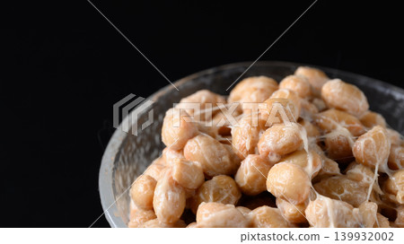 A close-up of natto served in a small glass bowl. A close-up of natto served in a small glass bowl. 139932002