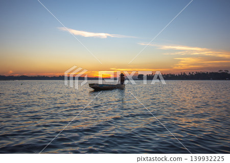 Traditional Fisherman Working on Wooden Boat at Sunset Traditional Fisherman Working on Wooden Boat at Sunset 139932225