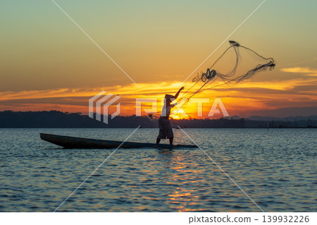 Traditional Fisherman Working on Wooden Boat at Sunset Traditional Fisherman Working on Wooden Boat at Sunset 139932226