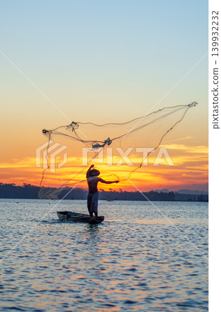 Traditional Fisherman Working on Wooden Boat at Sunset Traditional Fisherman Working on Wooden Boat at Sunset 139932232