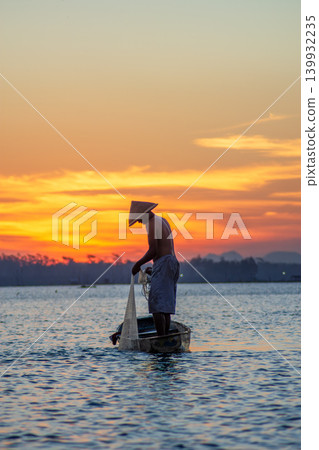 Traditional Fisherman Working on Wooden Boat at Sunset Traditional Fisherman Working on Wooden Boat at Sunset 139932235