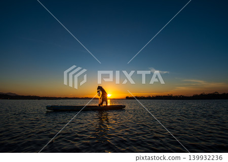 Traditional Fisherman Working on Wooden Boat at Sunset Traditional Fisherman Working on Wooden Boat at Sunset 139932236