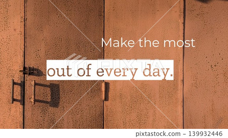 A quote, Make the most out of every day, is displayed on a textured, reddish-brown surface with a speckled pattern. A metal handle and latch cast shadows, adding visual interest to the doors. A quote, Make the most out of every day, is displayed on a textured, reddish-brown surface with a speckled pattern. A metal handle and latch cast shadows, adding visual interest to the doors. 139932446