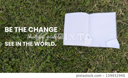 The uplifting quote, BE THE CHANGE you wish to SEE IN THE WORLD, is displayed next to an open book with blank pages lying on a bright green lawn, hinting at a new beginning. The uplifting quote, BE THE CHANGE you wish to SEE IN THE WORLD, is displayed next to an open book with blank pages lying on a bright green lawn, hinting at a new beginning. 139932948