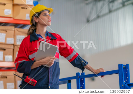 Warehouse worker working in warehouse storage.  139932997