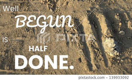Quote is laid over a textured sandy ground with faint tracks. The text "Well BEGUN IS HALF DONE" is creatively arranged, with the main words emphasized to highlight the importance of starting a task. Quote is laid over a textured sandy ground with faint tracks. The text "Well BEGUN IS HALF DONE" is creatively arranged, with the main words emphasized to highlight the importance of starting a task. 139933092