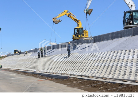 Leveling of the embankment slopes using heavy machinery in the Edogawa floodway 139933125