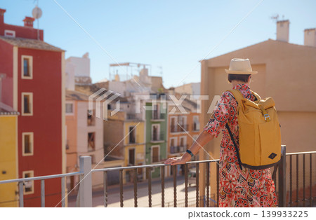 Woman strolls through colorful streets of Spanish coastal town 139933225