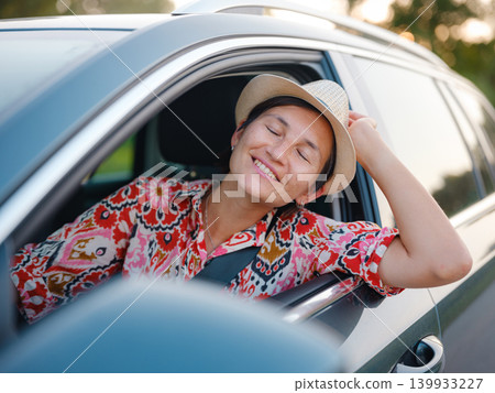 Traveler woman drives car through scenic countryside of Croatia Traveler woman drives car through scenic countryside of Croatia 139933227