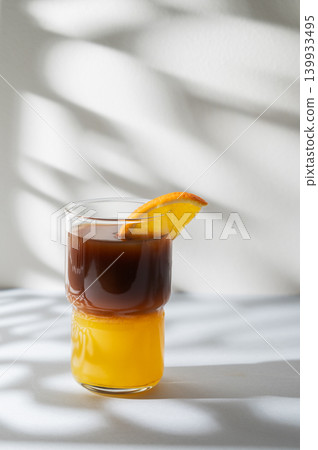Cold bumble coffee with orange juice and ice on light background 139933495