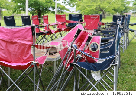 Myoden Riverside Green Space: Folding chairs prepared for barbecues and events on the lush outdoor lawn. Myoden Riverside Green Space: Folding chairs prepared for barbecues and events on the lush outdoor lawn. 139933513