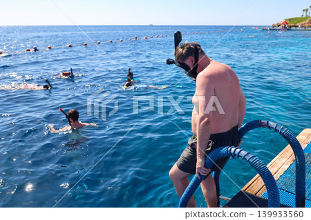 Egypt, Sharm El Sheikh - September 26, 2025 A group of people float on the surface of the sea with their heads in the water, exciting snorkeling on the beach of the Savoy Hotel. Editorial 139933560
