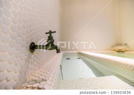 Old faucets and tiled bathtub Old faucets and tiled bathtub 139933636