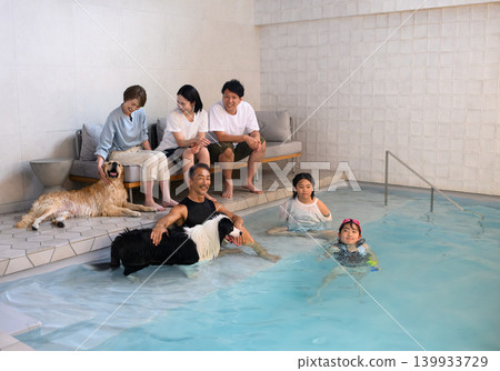 Relaxing in the pool with family and dog Relaxing in the pool with family and dog 139933729