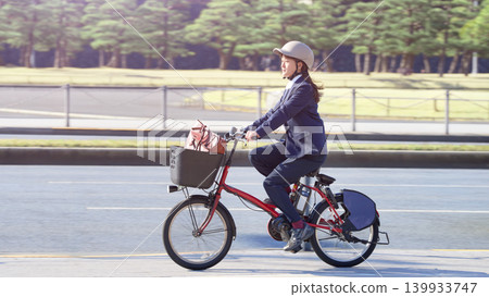 A young female office worker who commutes by bicycle A young female office worker who commutes by bicycle 139933747