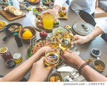 People toasting at the dinner table People toasting at the dinner table 139933763