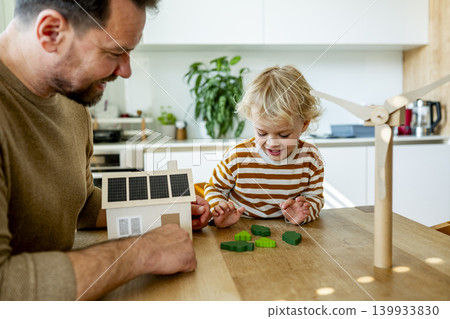 Father educating toddler about solar power and eco friendly living. 139933830