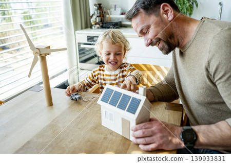Father educating toddler about solar power and eco friendly living. 139933831