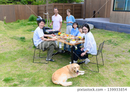 A family enjoying a barbecue in the garden A family enjoying a barbecue in the garden 139933854