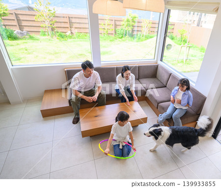 A family and dog relaxing in the living room A family and dog relaxing in the living room 139933855