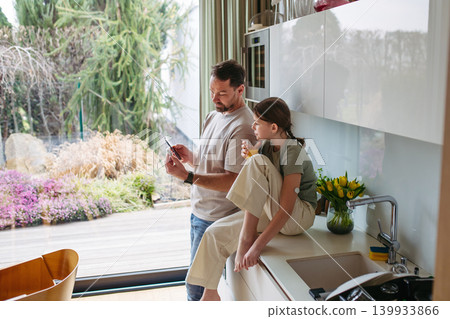 Diabetic girl and father checking her blood sugar level on phone. Diabetic girl and father checking her blood sugar level on phone. 139933866