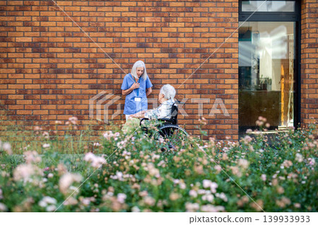 Nurse helping senior patient to find something in phone. Nurse helping senior patient to find something in phone. 139933933