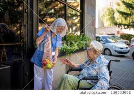 Home caregiver assisting older woman during grocery run 139933938