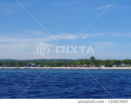 The beautiful white sandy beaches of Nusa Penida and the endlessly stretching azure sea as seen from a speedboat. The beautiful white sandy beaches of Nusa Penida and the endlessly stretching azure sea as seen from a speedboat. 139933993