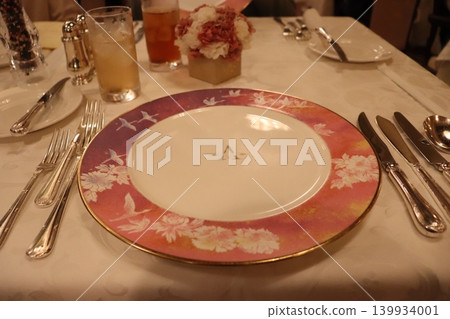 Plates and cutlery on a cruise ship Plates and cutlery on a cruise ship 139934001