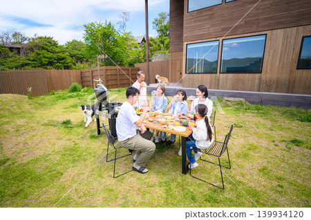 A family enjoying a barbecue in the garden A family enjoying a barbecue in the garden 139934120