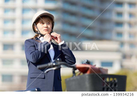 戴著自行車頭盔的女商人。 139934216